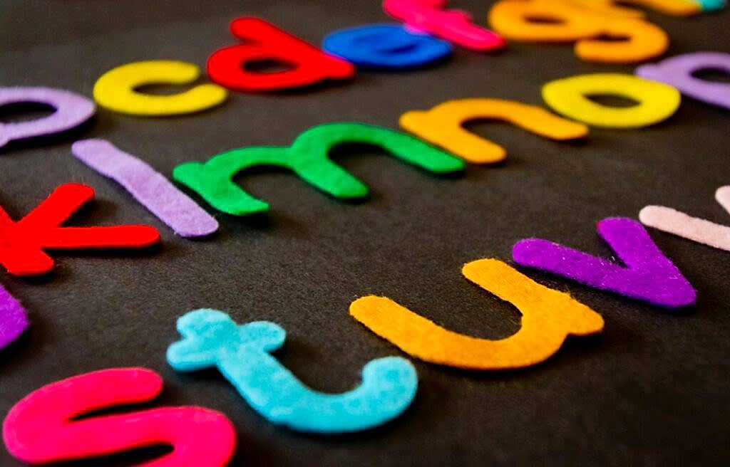 Bright and colorful felt alphabet letters arranged on a dark surface, perfect for educational and creative projects.