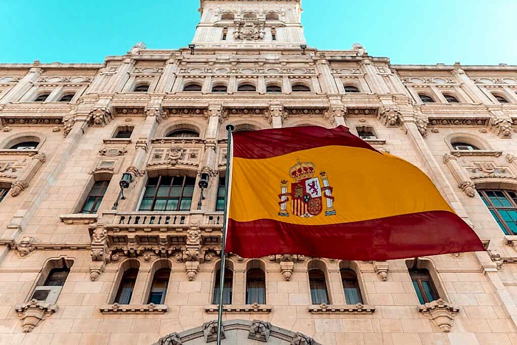 flag on pole beside building during day