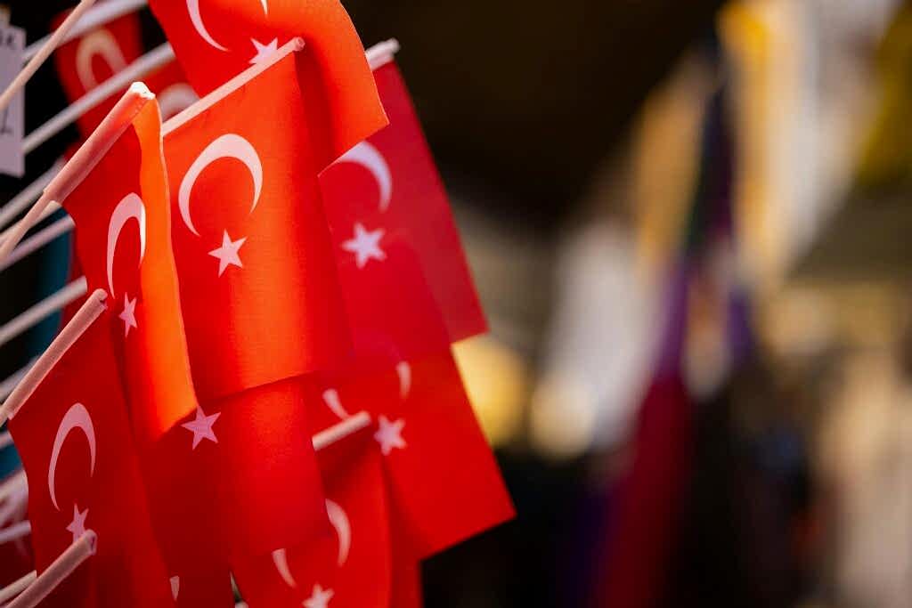 a row of red flags with white stars and crescents